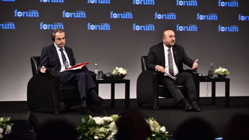 Former Spanish prime minister José Luis Rodríguez Zapatero (L) listens as Turkish Foreign Minister Mevlut Cavusoglu addresses the TRT World Forum, Istanbul, Turkey, October 19.