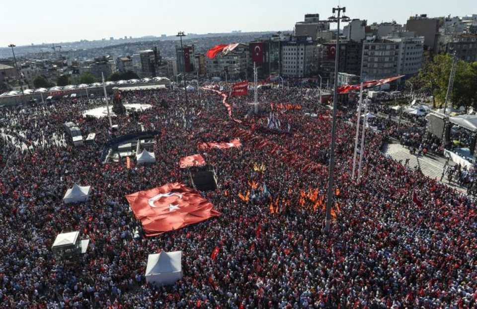 Supporters of various political parties shout slogans and hold Turkish flags in Istanbul's Taksim Square on July 24, 2016 during the first cross-party rally against July 15 coup attempt.