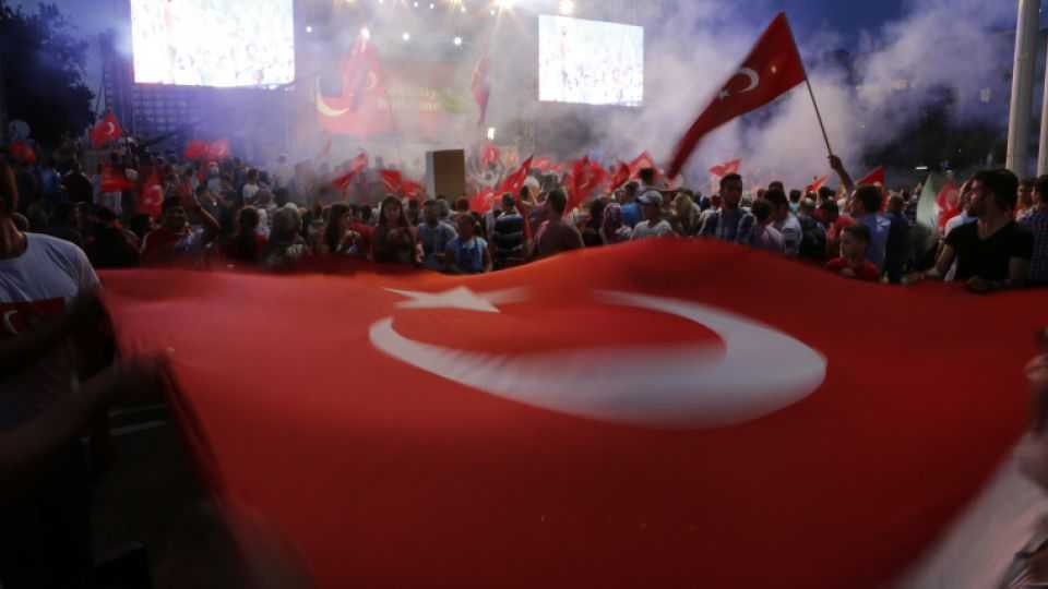 Protesters wave a large Turkish flag during an anti-coup rally in Taksim Square in Istanbul. July 25, 2016.