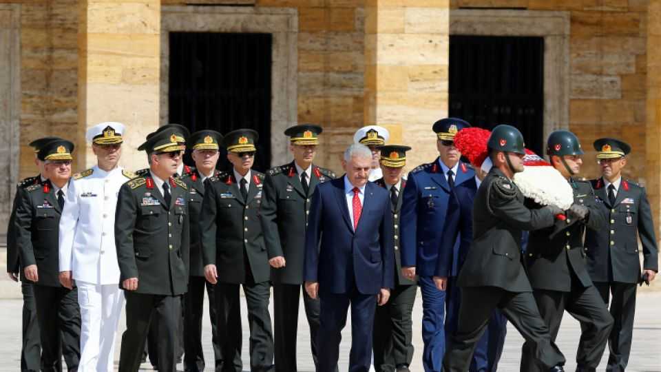 Turkish PM Binali Yildirim, flanked by Chief of Staff General Hulusi Akar and the country's top generals, attends a ceremony ahead of a military council meeting in Ankara. July 28, 2016.
