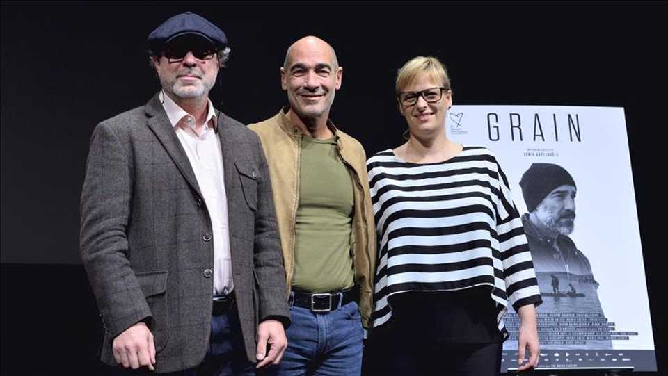 Turkish Director Semih Kaplanoglu (L), actor Jean-Marc Barr (C) and producer Bettina Brokemper (R) pose for the photo as they make a stage appearance after the screening of the movie ''Grain'' which competes in Competition category of the 30th Tokyo International Film Festival in Tokyo, Japan on October 28, 2017.