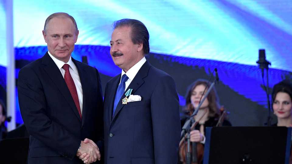 Russian President Vladimir Putin shakes hands with Turkish Businessman Cavit Caglar as he gives order of friendship to Caglar as part of Russian Unity Day Caglar in Moscow, Russia on November 04, 2017.