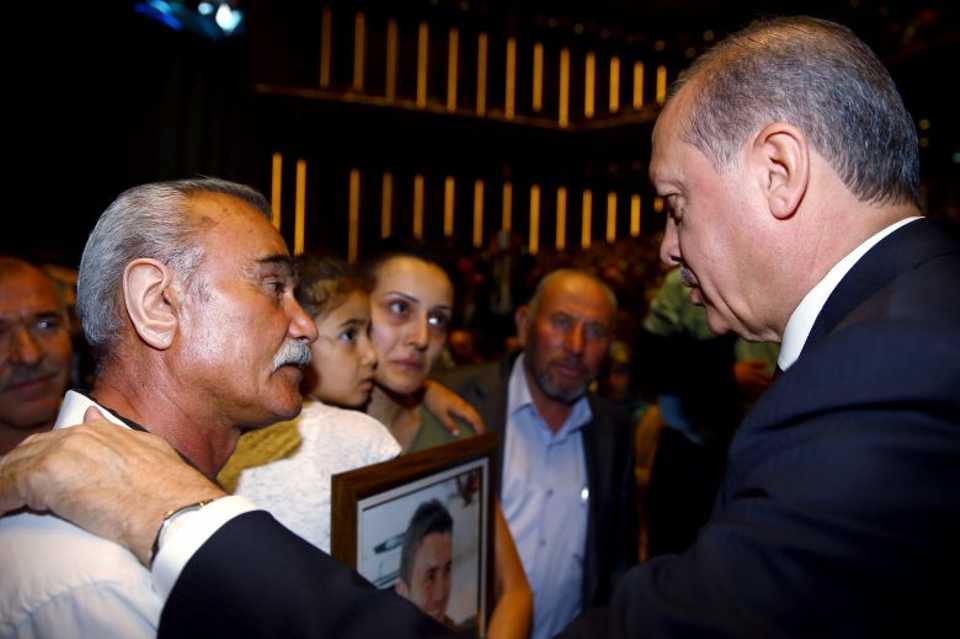 Turkish President Recep Tayyip Erdogan speaks with relatives of martyrs and veterans during the opening ceremony of Bestepe National Congress & Culture Center and commemoration of those martyred in July 15 coup attempt, in Ankara, Turkey on July 29, 2016.