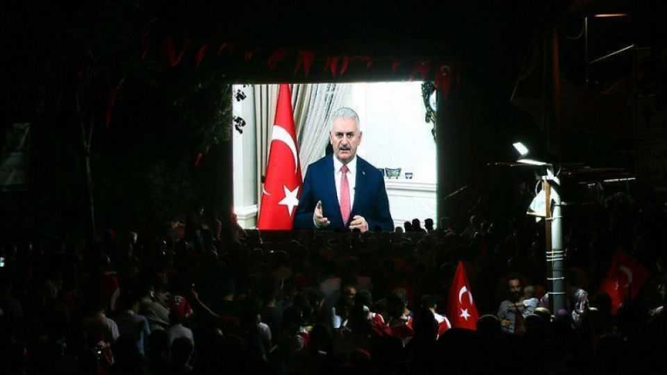 Turkish Prime Minister Binali Yildirim is seen addressing a rally in Ankara via video link.