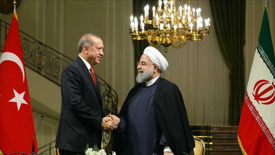 File photo shows Turkish President Recep Tayyip Erdogan (L) and Iranian President Hassan Rouhani (R) shaking hands during a joint press conference after their meeting at the Saadabad Palace in Tehran, Iran on October 4, 2017.