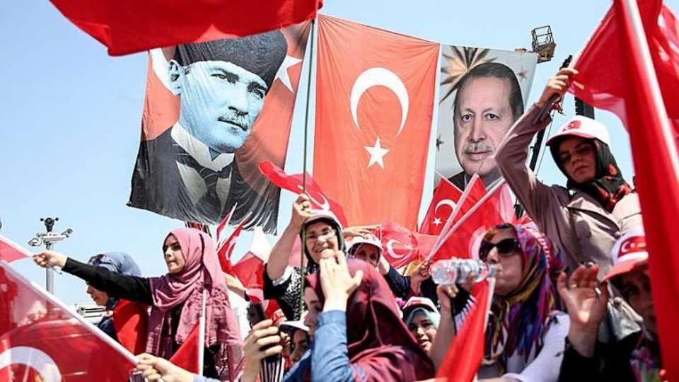 A flag bearing the image of the founder of the Republic of Turkey Mustafa Kemal Ataturk (L) alongside a flag bearing the image of Turkish President Recep Tayyip Erdogan (R). 