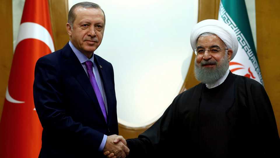 Turkish President Recep Tayyip Erdogan (L) and Iran's President Hassan Rouhani shaking hands before a meeting with Russia's President Vladimir Putin, in Sochi, Russia, November 22, 2017.