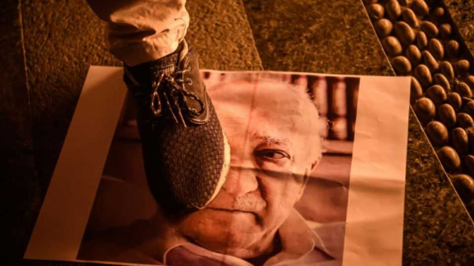 A man stamps over a poster with an image of Fethullah Gulen, the leader of terrorist organisation FETO.