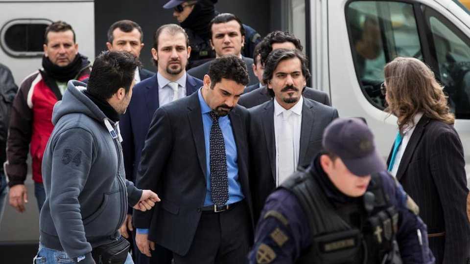 Eight former Turkish soldiers, who fled to Greece in a helicopter and requested political asylum after a failed military coup attempt against the government, are escorted by police officers as they arrive at the Supreme Court in Athens, Greece, January 26, 2017.