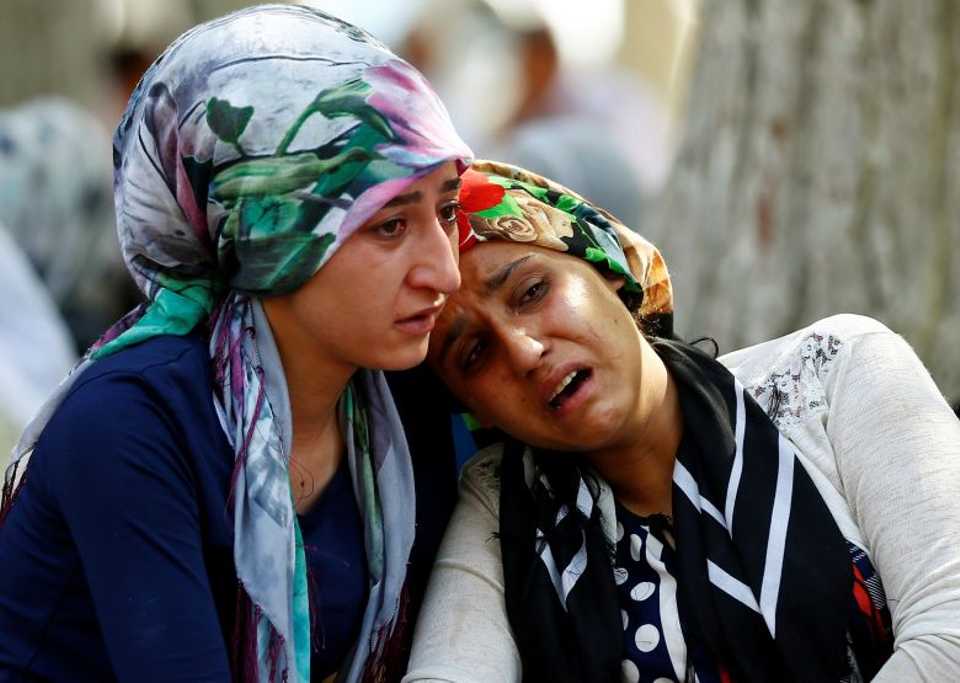 Women mourn as they wait in front of a hospital morgue in the Turkish city of Gaziantep, after a suspected bomber targeted a wedding celebration in the city, Turkey, August 21, 2016. 