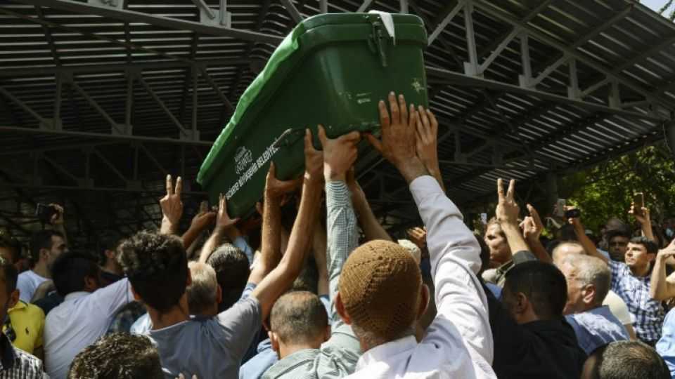 People hold a coffin during the funeral of the victims of an attack during a wedding party that left 50 dead in Gaziantep in southeastern Turkey near the Syrian border on August 21, 2016. 