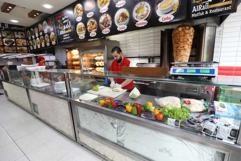 Hani, who is a Syrian working for a kebab shop, is making preparations for the busy lunch time in Istanbul's Fatih district on January 11, 2018.