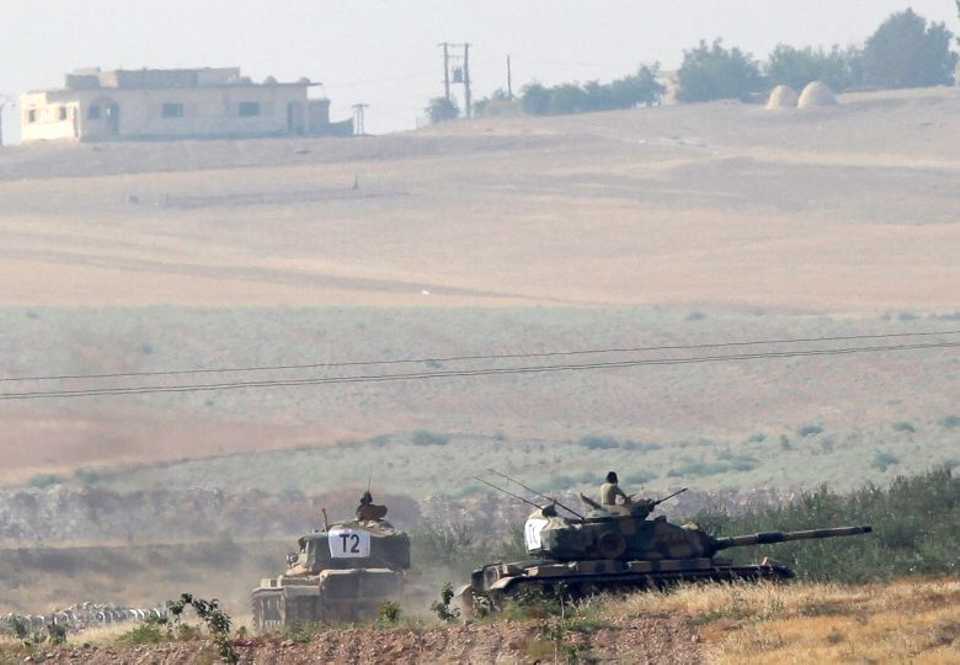Turkish army tanks are pictured in Karkamis on the Turkish-Syrian border in the southeastern Gaziantep province, Turkey, on August 24, 2016.
