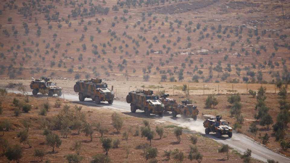 Turkish armoured military vehicles patrol on the Turkish-Syrian border line in Reyhanli, Hatay province, Turkey on October 8, 2017.