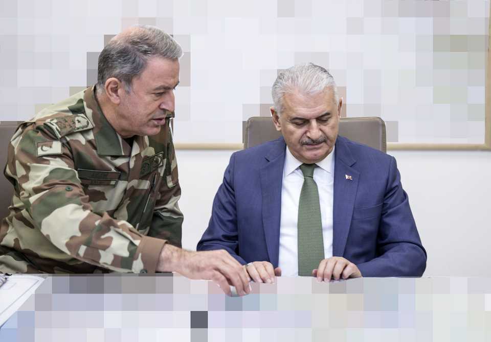 Turkish Chief of General Staff General Hulusi Akar gives information to Turkish Prime Minister Binali Yildirim on 'Operation Olive Branch' to Afrin, at the operations center in the Turkish General Staff Headquarters in Ankara, Turkey on January 20, 2018.
