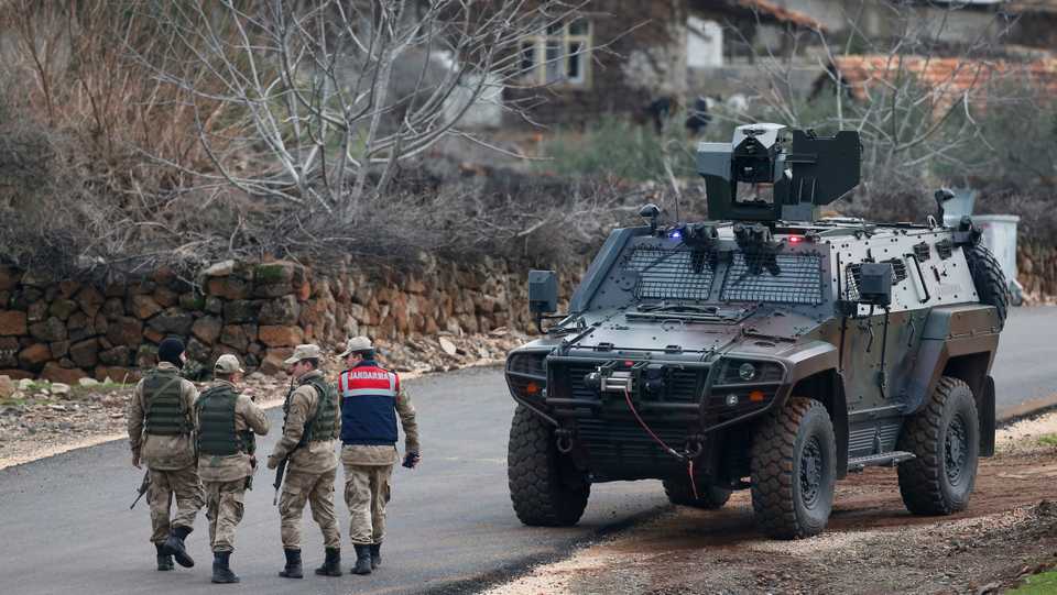 Turkish Army officers block the outskirts of the village of Sugedigi, Turkey, on the border with Syria, Sunday, Jan. 21, 2018.