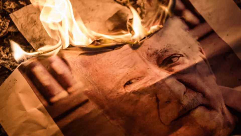 A poster with the face of US-based terrorist leader Fethullah Gulen burns during a Pro-democracy rally in Istanbul, Turkey.
