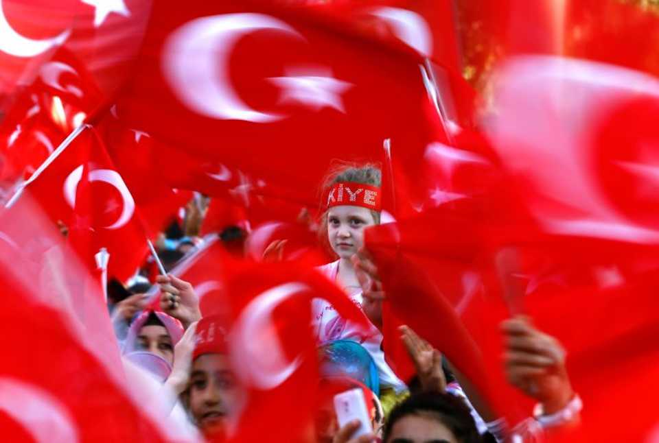 People wave national flags as they wait for Turkey's President Tayyip Erdoğan arrival to the United Solidarity and Brotherhood rally in Gaziantep, Turkey, August 28, 2016.