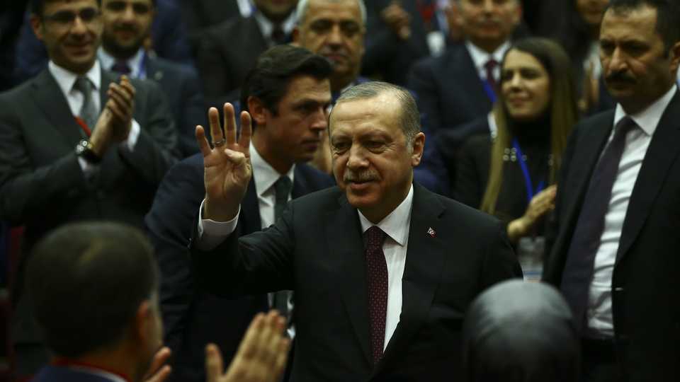 Turkish President Recep Tayyip Erdogan (C) greets the crowd as he arrives to attend Turkey's governing Justice and Development (AK) Party’s extended meeting of provincial heads at the AK Party's headquarters in Ankara, Turkey on January 26, 2018.