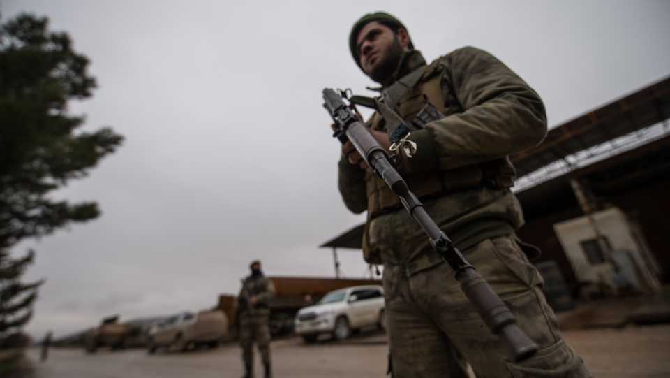 Members of Free Syrian Army (FSA), backed by Turkish Army, patrol a passage route, within the 