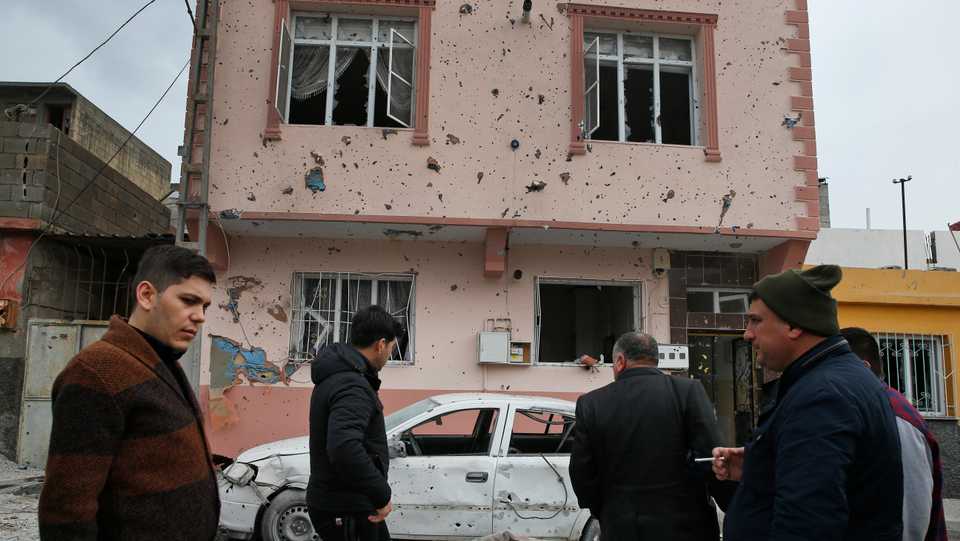 People look at the damage caused by a rocket fired overnight from Syria, across the border into the town of Kilis, Turkey, January 21, 2018.
