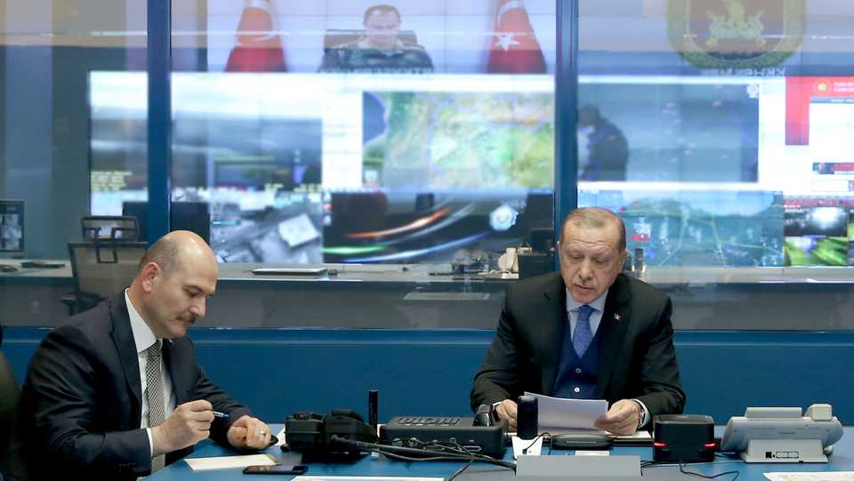 Turkish President Recep Tayyip Erdogan (R), Turkish Interior Minister Suleyman Soylu (L) and other officials gather to receive information about the third day of the 'Operation Olive Branch' to Afrin, from the commanders in the area via video conference in Ankara, Turkey on January 23, 2018.