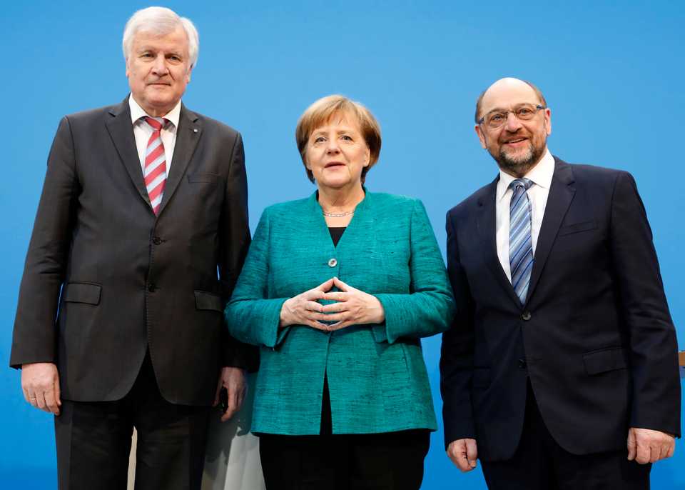 Christian Democratic Union (CDU) leader and German Chancellor Angela Merkel, Christian Social Union (CSU) leader Horst Seehofer and Social Democratic Party (SPD) leader Martin Schulz pose after a statement on coalition talks to form a new coalition government in Berlin,Germany, February 7, 2018.