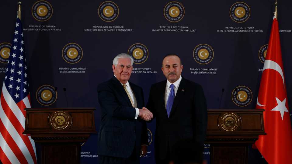 Turkish Foreign Minister Mevlut Cavusoglu (R) and US Secretary of State Rex Tillerson (L) shake hands during a joint press conference following their meeting in Ankara, Turkey on February 16, 2018.
