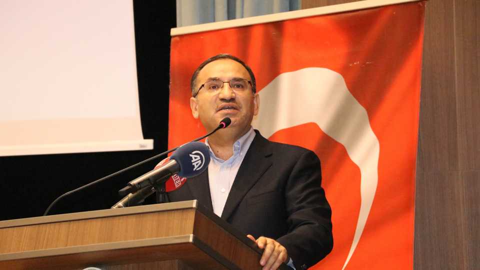 Turkey's Deputy Prime Minister Bekir Bozdag, speaks during a conference says that Turkey has demanded the extradition of the the former leader of the YPG.