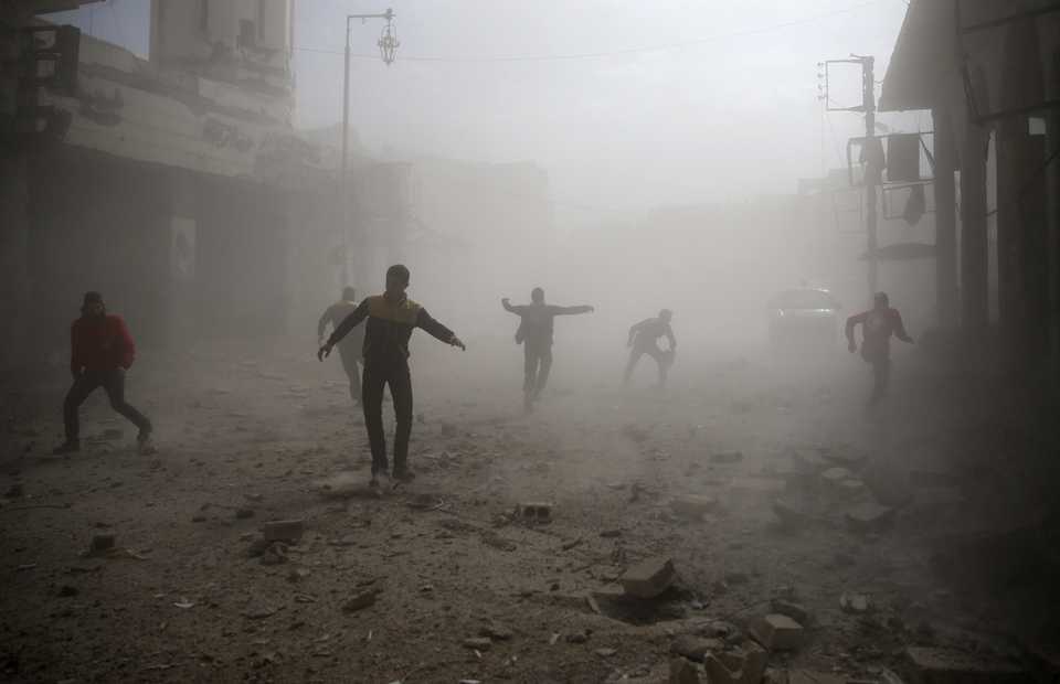Assad regime’s brutal military machine has been bombing civilian areas in the ongoing civil war. Civil defence members and civilians are seen running after an air raid in the besieged town of Douma in eastern Ghouta in Damascus, Syria, on February 6, 2018.