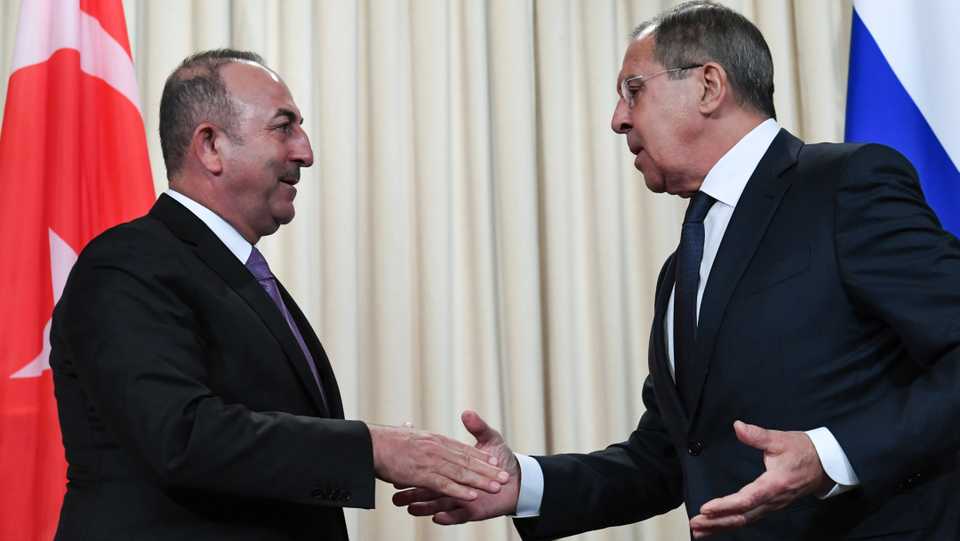 Russian Foreign Minister Sergey Lavrov (R) shakes hands with his Turkish counterpart Mevlut Cavusoglu at the end of a joint press conference following their meeting in Moscow on March 14, 2018