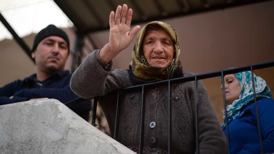 A local resident welcomes Free Syrian Army member in town centre after Turkish Armed Forces and Free Syrian Army (FSA) took complete control of northwestern Syria's Afrin within the 