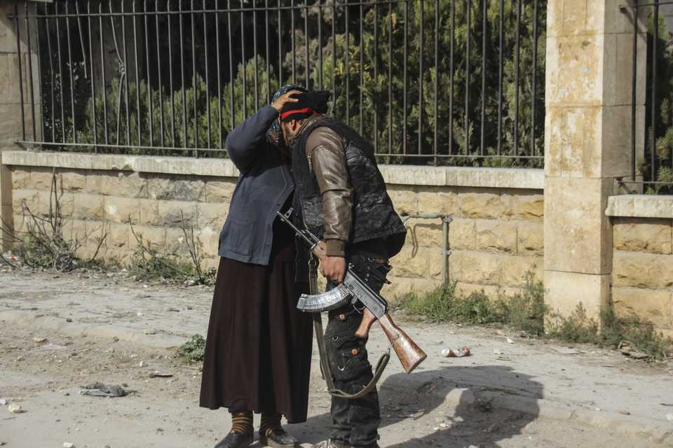 A local resident kisses a Free Syrian Army (FSA) member after the Turkish military and the FSA cleared the area of the YPG on March 18, 2018.