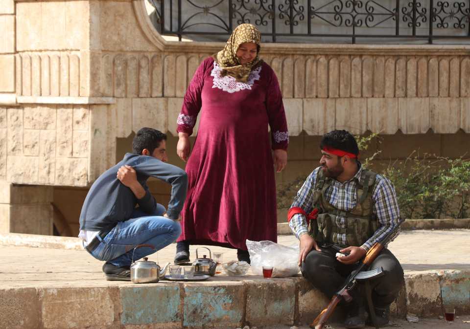 A local resident offers tea to Free Syrian Army members in Afrin, Syria, on March 18, 2018.