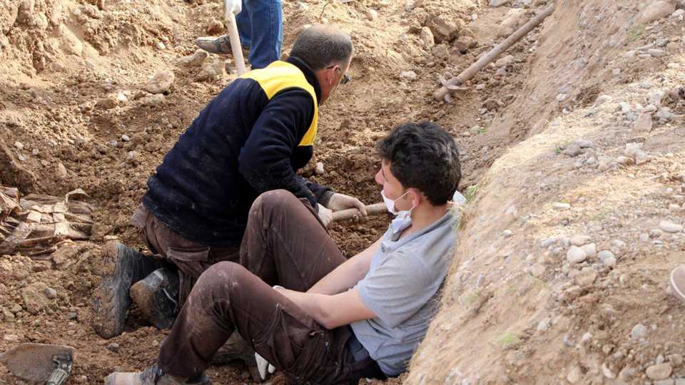 Members of White Helmet dig the area after Free Syrian Army fighters found mass grave in recently secured Kucuk Meydan village during search efforts after getting information from the PKK-affiliated YPG terrorists held in Afrin, Syria on March 25, 2018.