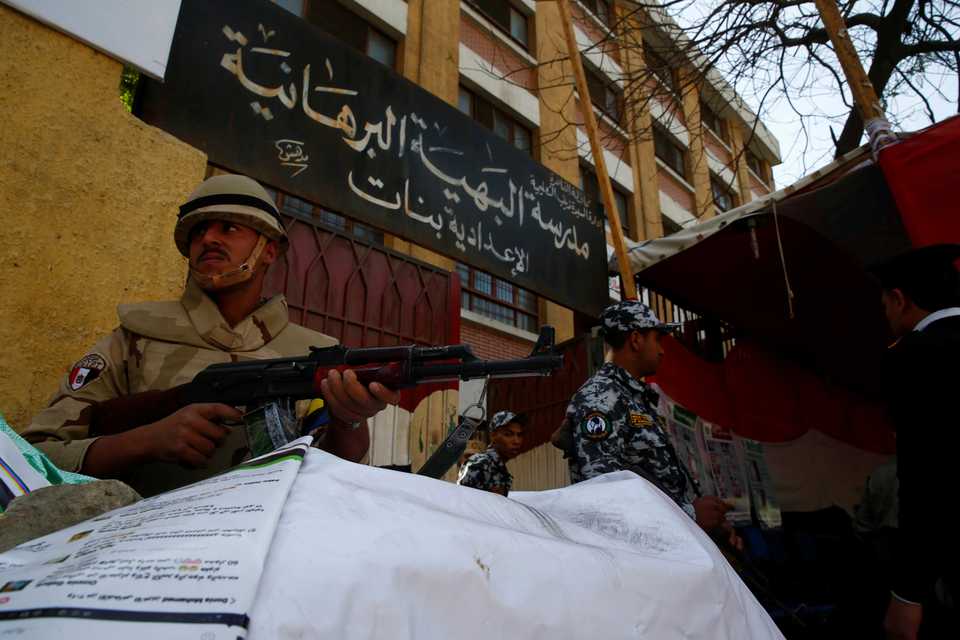 An Egyptian soldier keeps guard outside a polling station during the presidential election in Cairo, on March 26, 2018.