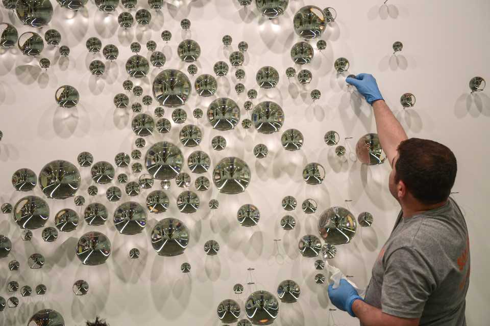 A worker collects pieces of an artwork for packing at Istanbul Modern museum in Istanbul, March 23, 2018.