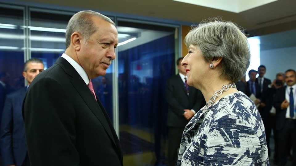 File Photo: Turkish President Recep Tayyip Erdogan (L) told the UK's PM Theresa May (R) that Ankara considers the air strikes against the Assad regime were 