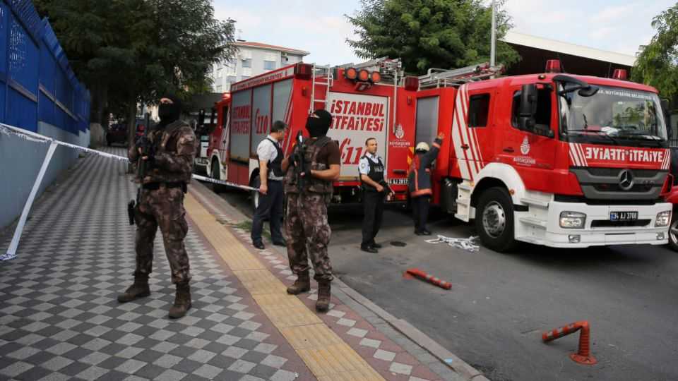 Members of police special forces stand next to a fire truck near the blast site in Istanbul.
