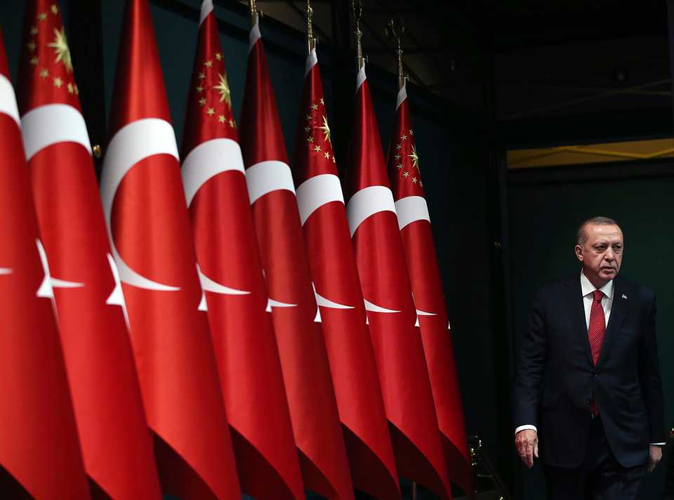 In this April 18, 2018 file photo, Turkish President Recep Tayyip Erdogan walks before announcing early presidential and parliamentary elections, at the Presidential complex, in Ankara, Turkey.