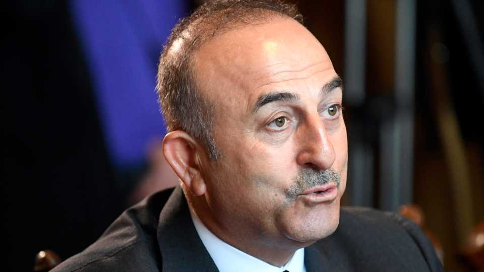 Turkish Foreign Minister Mevlut Cavusoglu, seen here in a file picture, says the country will not bow to foreign pressure to cut ties with Iran.