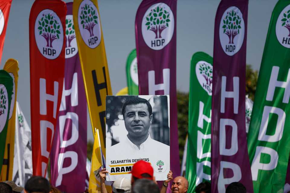 A demonstrator holds up a poster of Selahattin Demirtas, the jailed former co-leader of the HDP (Peoples' Democratic Party), during a May Day rally in Istanbul, Turkey, May 1, 2018.
