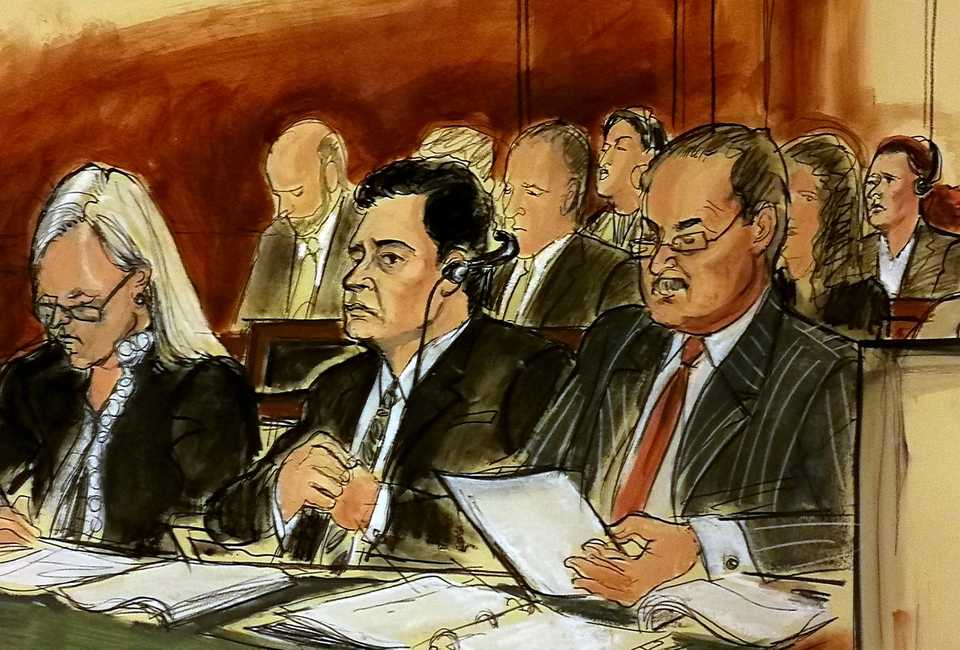In this courtroom sketch Mehmet Hakan Atilla, second from left, listens to the judge during his sentencing, flanked by his attorneys Cathy Fleming, left, and Victor Rocco as Atilla's wife, upper right, listens to the proceedings Wednesday, May 16, 2018, in New York.