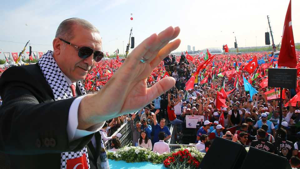 Turkish President Recep Tayyip Erdogan greets people during rally in solidarity with Palestinians.