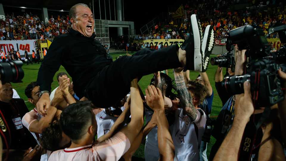 Galatasaray coach Fatih Terim is lifted by his jubilant players after the team defeated Gostepe 1-0 in Izmir on Saturday and claimed a record 21 league title.
