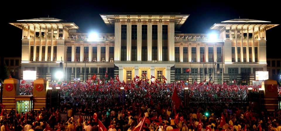 In this August 10, 2016 file photo, people gather outside the Presidential Palace in Ankara to denounce the failed coup attempt as Turkish President Recep Tayyip Erdogan delivers a speech.