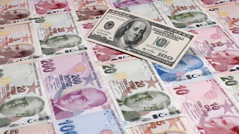 A photo illustration shows a $100 banknote against Turkish lira banknotes of various denominations, January 7, 2014.