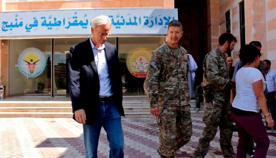 American Major General James Jarrard, center, and veteran Middle East diplomat William Roebuck, left, visit the city of Manbij, in Aleppo province, Syria, on June 7, 2018.