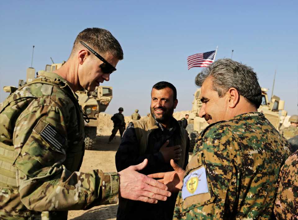 This February 7, 2018 file photo, shows US Army Major General Jamie Jarrard, left, thanking Manbij Military Council member Muhammed Abu Adeel in the city of Manbij, Syria.