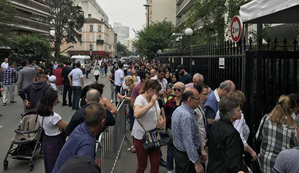 Voters join a long queue to cast their vote for the elections in Turkey, at a polling station of the Paris Turkish Consulate General on June 10, 2018.
